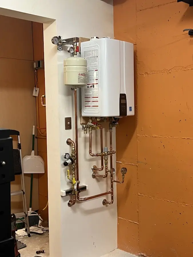 Plumbing technician inspecting water heater connections in Red Bluff